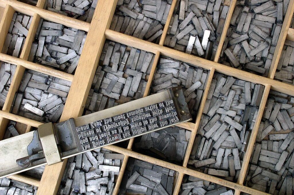Metal movable type letters arranged in a wooden letterpress type case